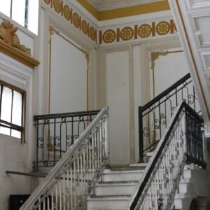 A staircase in a large building with white railings